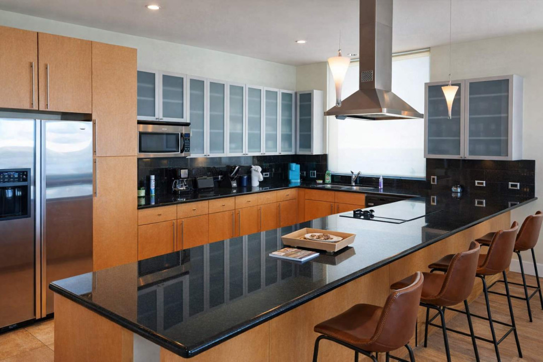 Modern Kitchen Retreat – Stainless Steel Appliances, Granite Island, Coffee Station, and Sleek Design for Comfortable Stays Near the Beach