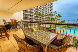 Spacious Balcony Dining with Pool Views
Generous balcony at Royale Beach & Tennis Club offers wicker dining set overlooking resort pool, tennis courts, and high-rise towers. Palm accents, gentle breeze—perfect al fresco spot for sunset cocktails. 