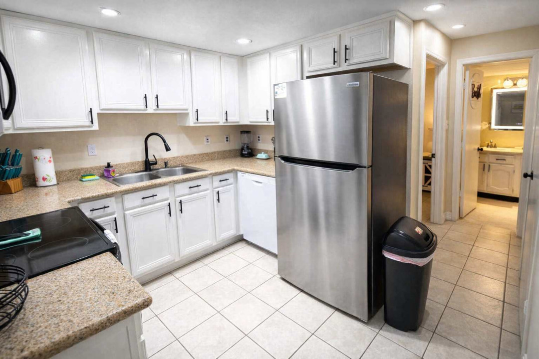 Modern Kitchen with Stainless Steel Appliances, Granite Counters, and Bright Lighting—Perfect for Cooking and Entertaining in a Clean, Well-Equipped Space