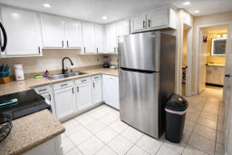 Modern Kitchen with Stainless Steel Appliances, Granite Counters, and Bright Lighting—Perfect for Cooking and Entertaining in a Clean, Well-Equipped Space