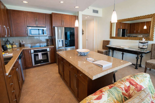 Modern Island Kitchen + Tropical Touches Near Beach
Warm wood cabinetry, granite counters, stainless steel appliances, and inviting decor—perfect for relaxing, cooking, and entertaining in a coastal retreat.