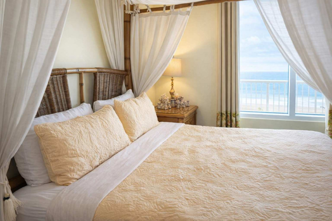 Coastal Canopy Retreat | Ocean View | Steps to Beach  
Relax in this breezy, beach-inspired bedroom with a four-poster bed, natural textures, and bright coastal charm. Perfect for couples or solo travelers seeking serenity by the sea.