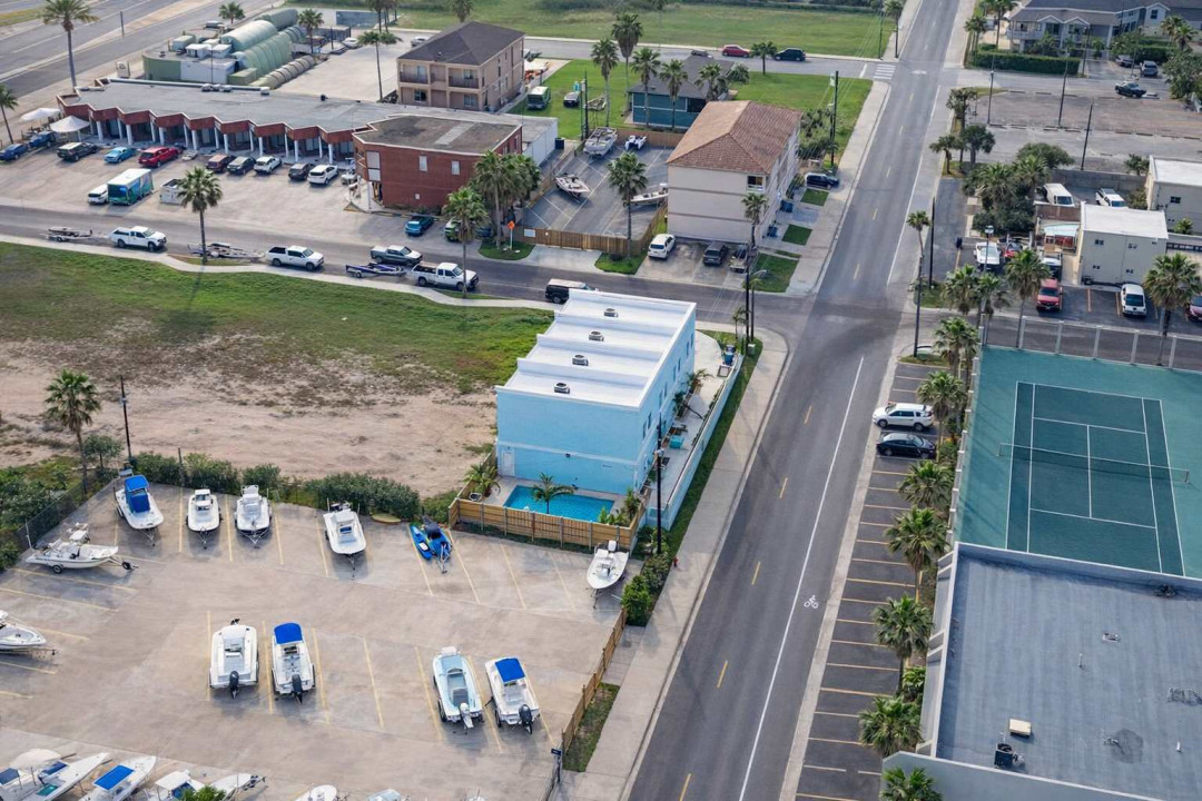 Bright coastal retreat with private pool, boat parking, and tennis courts—steps from beachside fun and dining. Ideal for families or groups seeking sun, space, and convenience in a vibrant vacation hub.