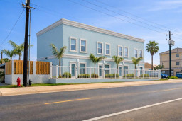 Modern 4-Unit Coastal Retreat with Heated Pool, Palm-Lined Fence, Lounge Chairs, BBQ Area & Walkable Beach Access — Ideal for Families & Groups Seeking Sun, Style, and Comfort