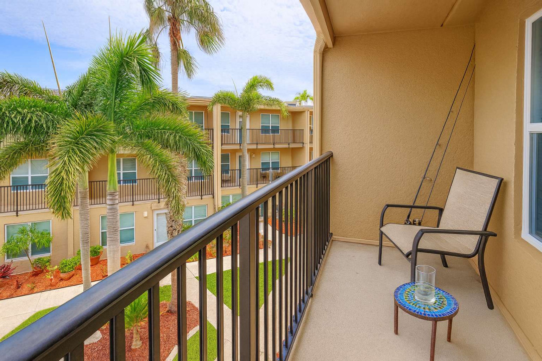 Unwind on your balcony with relaxing views of lush palms and courtyard below. Enjoy a quiet drink, cast a line with the provided fishing pole, or simply soak up the island breeze in this peaceful outdoor retreat.