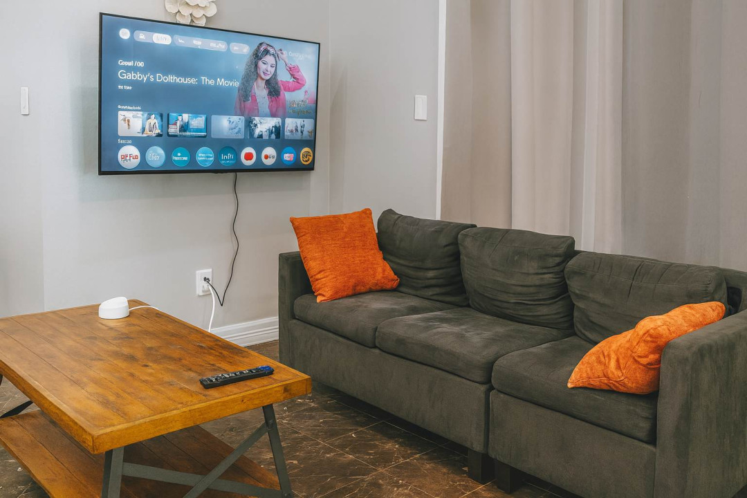 Cozy Living Room w/ Smart TV
Plush gray sectional w/ orange accents invites lounging! 55" smart TV for streaming, wood coffee table, airy light-filled space. Perfect chill spot after beach adventures. 