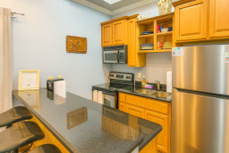 Sunny Kitchen w/ Bar & Essentials
Warm wooden cabinets, granite bar seating 4, SS fridge & microwave shine! Spacious for group meals, fully stocked. Coastal art & light-filled—cook up beachy feasts effortlessly!