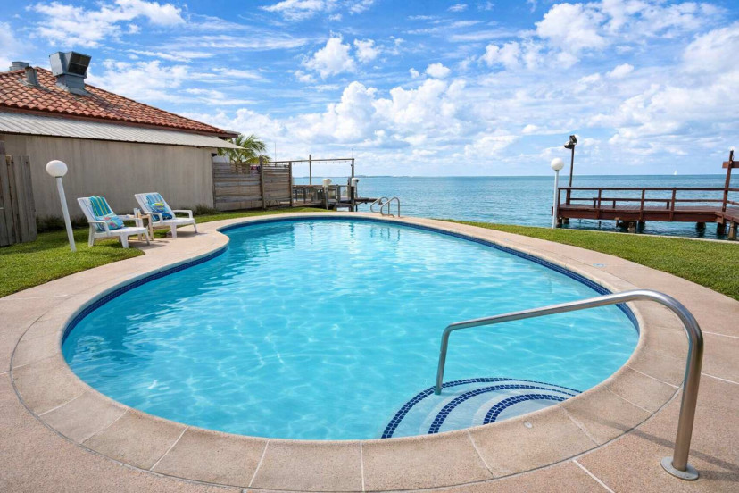 Waterfront Escape with sparkling Pool & Pier Access – Relaxing Views, Breezy Deck, and Serene Vibes