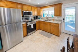 Modern kitchen with stainless steel appliances, granite countertops, and natural light—fully equipped for cooking and entertaining.