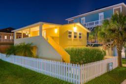 Charming Yellow Coastal Cottage Glow
Cozy yellow beach house shines at night! Wraparound porch, palms, white picket fence—perfect SPI retreat near 113 E Pompano St. Steps to sands, harbor views & SpaceX action. Unwind in tropical bliss!