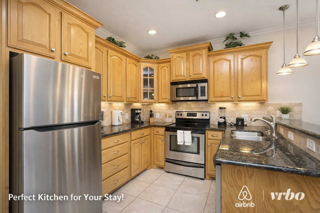 Modern Kitchen with Stainless Steel Appliances, Granite Counters & Cozy Lighting – Perfect for Your Stay!