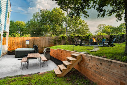 Relax and unwind in our hot tub on the back patio, which also features a gas grill and outdoor eating area. +firepit and Adirondack chairs
