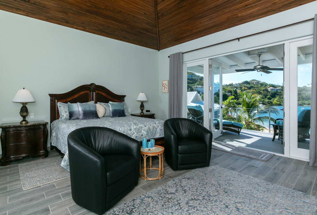 King suite with a private balcony overlooking the beach and water.