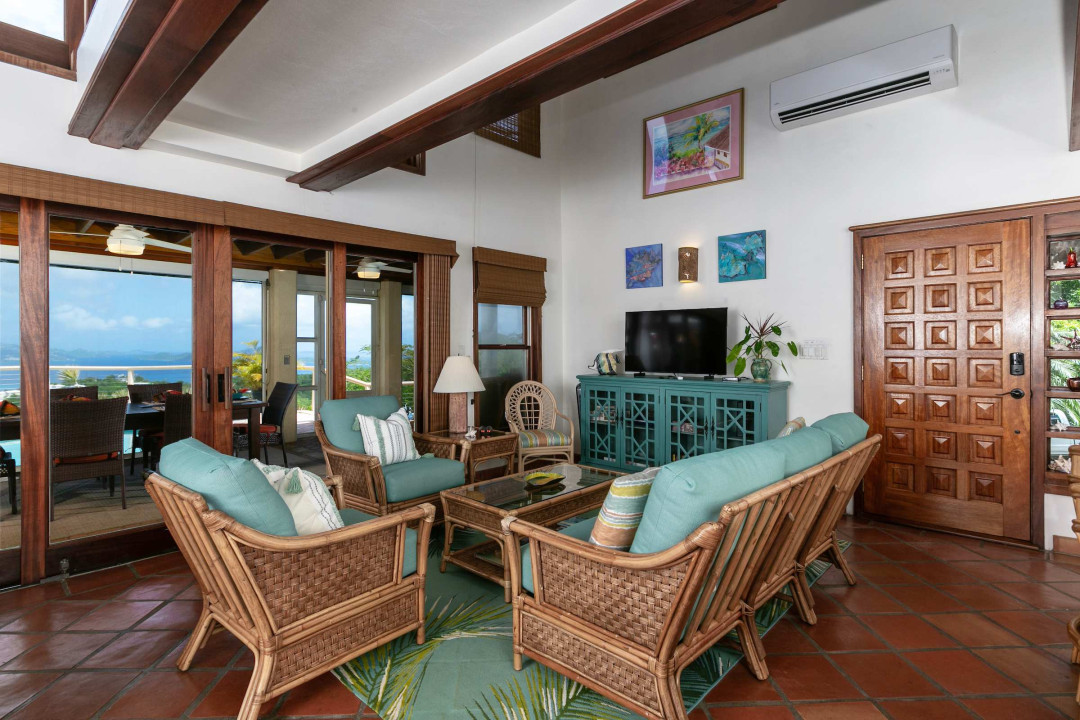 Comfy living space that opens into the outdoor screened area and pool