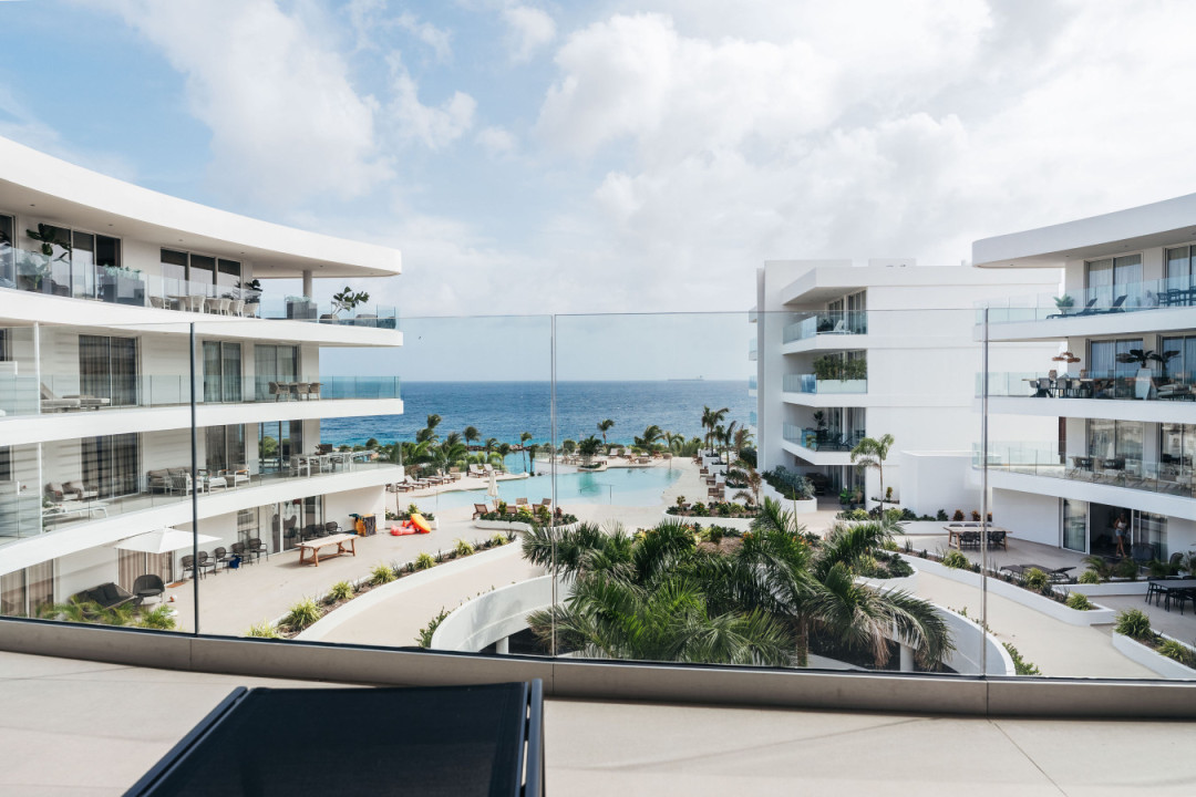 Spacious balcony with comfortable seating and beautiful views of the pool and ocean—an ideal spot to relax, enjoy the breeze, and take in the scenery at One Mambo 31.