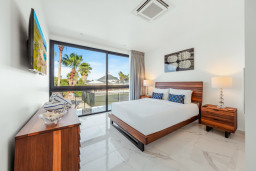 Wake up to palm tree views and plenty of natural light in this bright, comfortable bedroom — a peaceful spot to recharge after a day by the beach.
