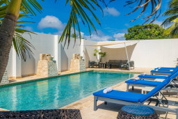 Relax by the sparkling pool, enjoy sun-filled days on the lounge chairs, and unwind in the comfort of this modern villa. Perfectly situated for an unforgettable vacation experience.