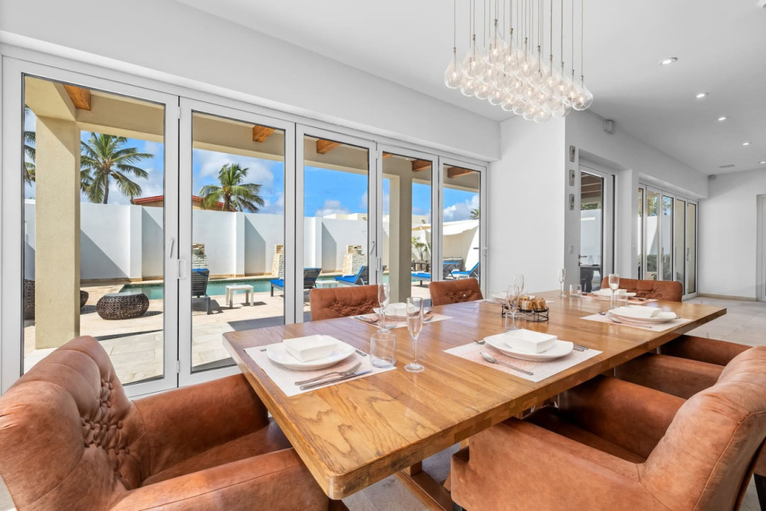 The dining area opens onto the entertaining living room overlooking the outside space and pool, setting the stage for many memorable evenings