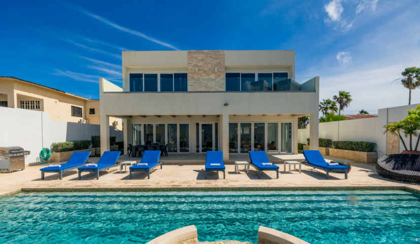 Relax by the sparkling pool, enjoy sun-filled days on the lounge chairs, and unwind in the comfort of this modern villa. Perfectly situated for an unforgettable vacation experience.