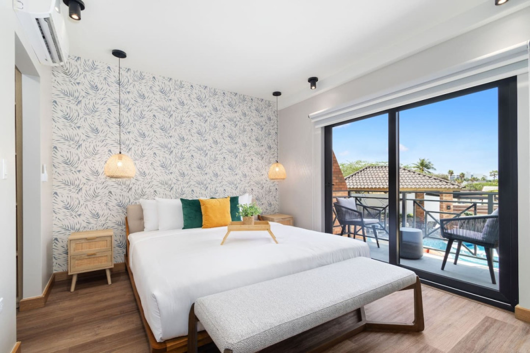 Relax and unwind in the luxurious comfort of Porta Al Sole's master bedroom, featuring a king-size bed, private balcony, and a TV for entertainment. With stylish furnishings and ample space, this tranquil retreat is your sanctuary.