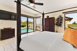 Master Bedroom 3 | The light-filled romantic master bedroom has has a king-size Balinese wood-carved four-poster bed, pool views and direct pool access. The master suite also boasts a 58’’ Ruko TV.