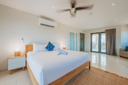 This master bedroom features a king bed, cozy sofa bed, and a private balcony for those peaceful morning coffee moments.