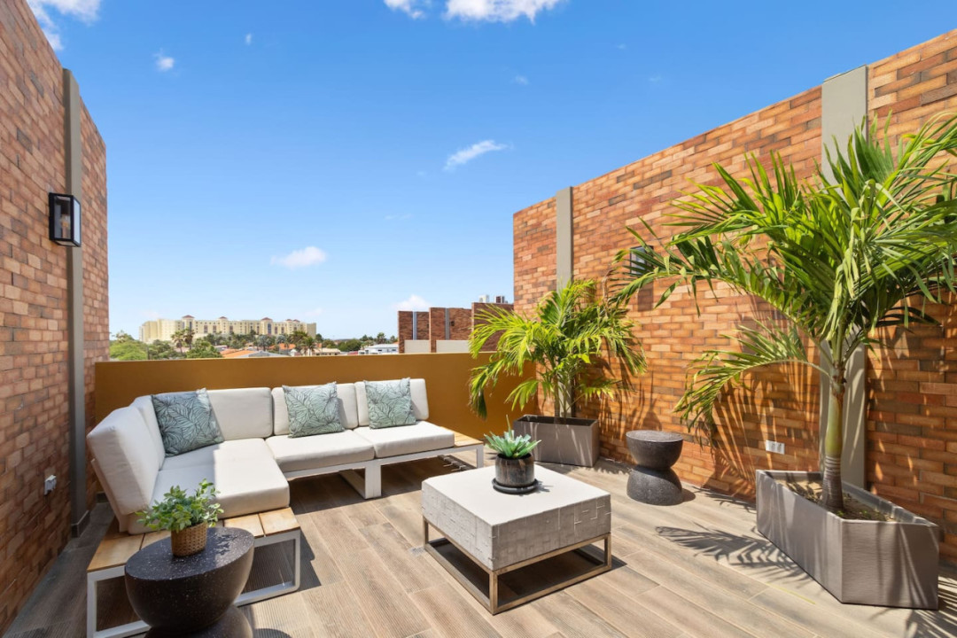 Step into relaxation at Porta Al Sole's private rooftop terrace, a tranquil oasis where every moment is a celebration of coastal living. With a comfortable lounging area and lush surroundings, this outdoor retreat invites you to unwind in style.