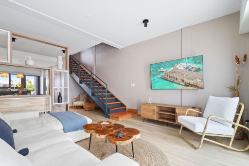 Welcome to the heart of Porta Al Sole – the spacious living room, adorned with a large sofa and a TV, beckoning you to unwind and relax. Bathed in natural light, this inviting space offers the perfect setting for gatherings with loved ones.