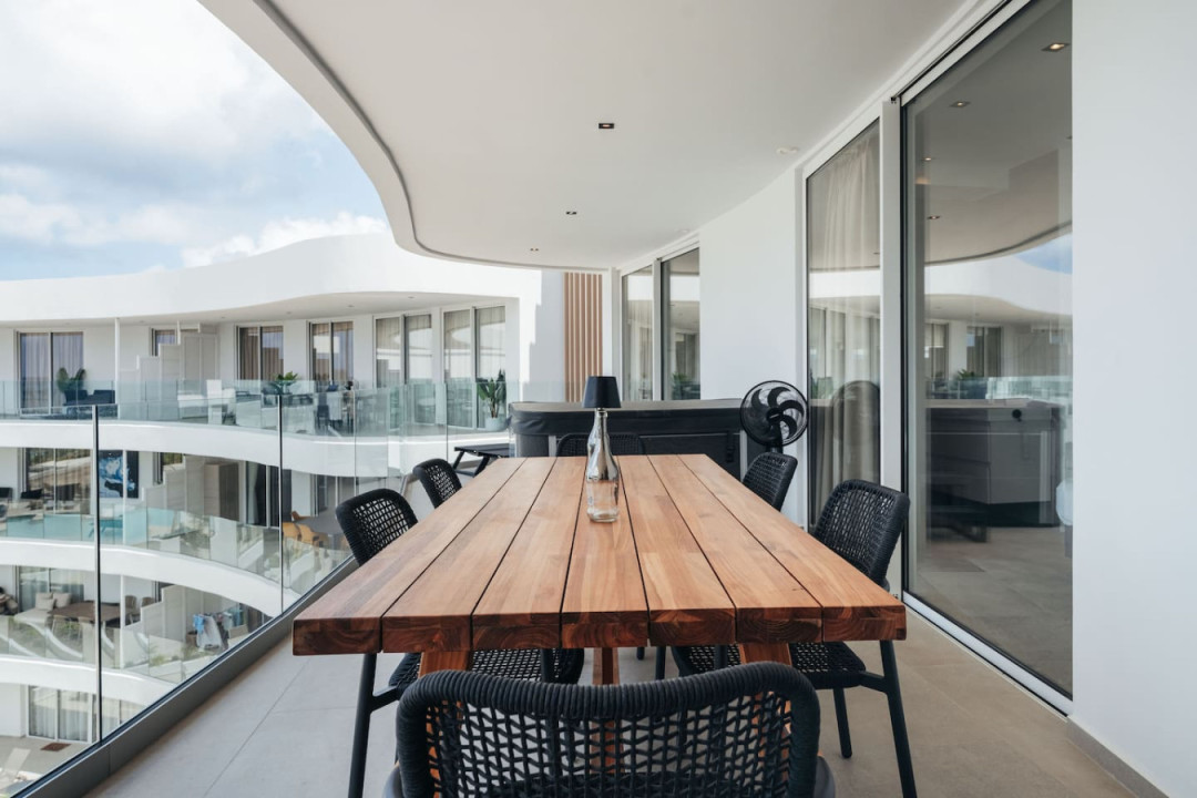 A spacious private balcony with a large dining table for enjoying meals outdoors.