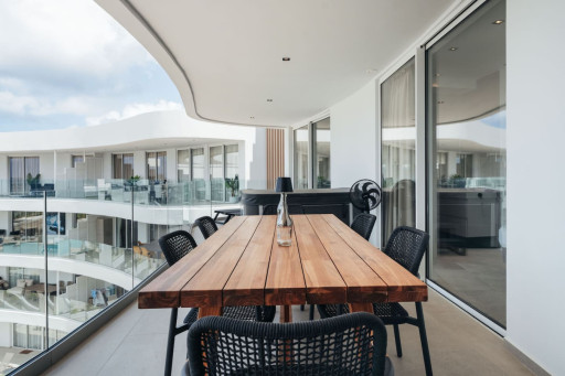 A spacious private balcony with a large dining table for enjoying meals outdoors.