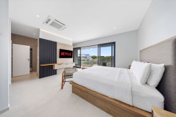 Master bedroom 1 with King-Size Bed, Smart TV, Ensuite Bathroom, Balcony.