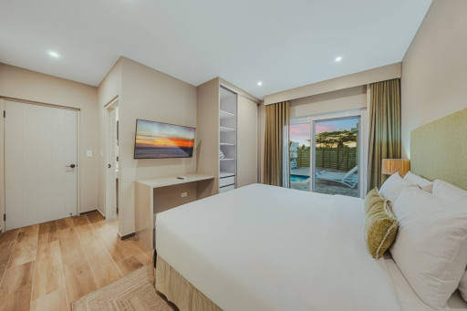 Wake up just steps from the pool in this bright and cozy bedroom, complete with a plush bed, smart TV, and everything you need for a comfortable stay.