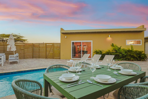 Enjoy meals by the pool, unwind in the island breeze, and make lasting memories in this inviting outdoor gathering space.