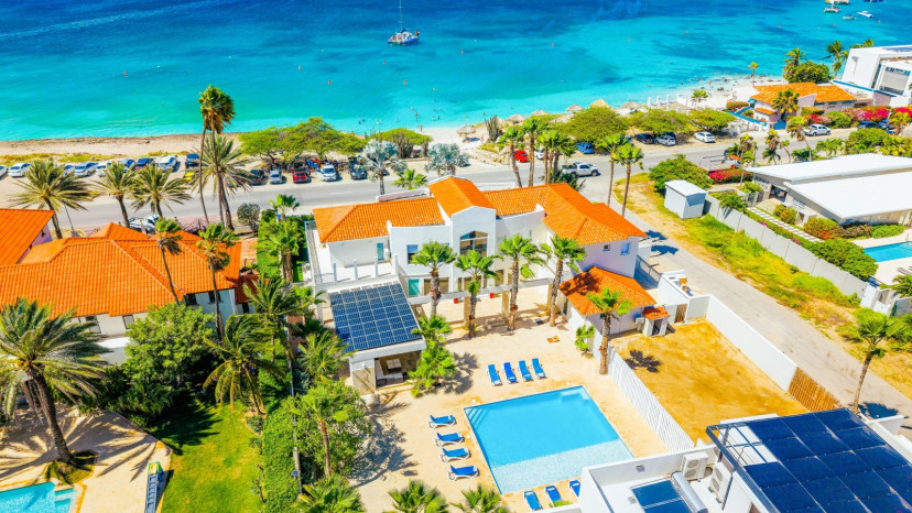 Wake up to the Caribbean Sea at Blue Door Beach House, a spacious 7-bedroom beachfront villa in Aruba's exclusive Malmok area, Aruba's quieter side of luxury - low-rise villas, uninterrupted ocean views, and calm reef waters perfect for snorkeling right o