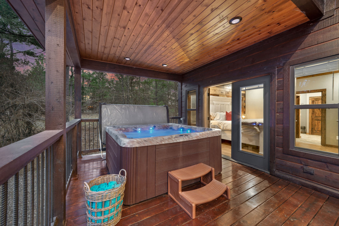 Our spacious hot tub on the deck overlooks the pines and natural scenery of Broken Bow.