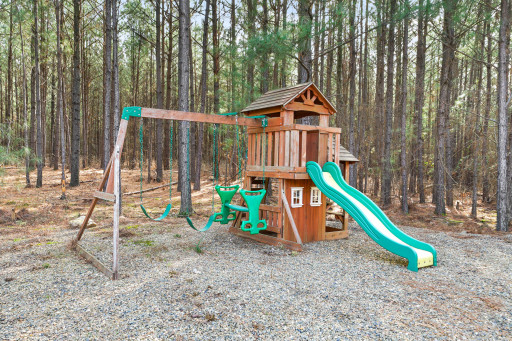 Keep the kids entertained with the outdoor playset with swings, a slide, and playhouse.