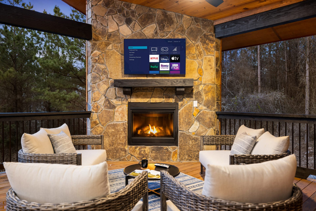 Our deck is truly a relaxation haven complete with cozy chairs, a fireplace, and a Smart TV.